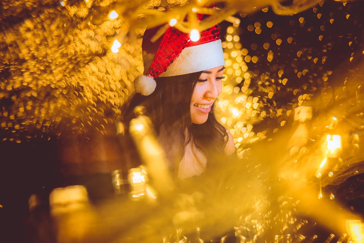 Girl with Christmas lights smiling